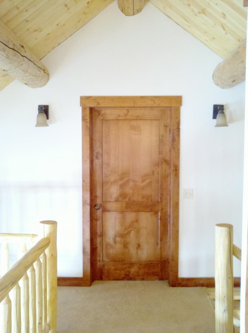 Knotty alder two panel door with flat panels.