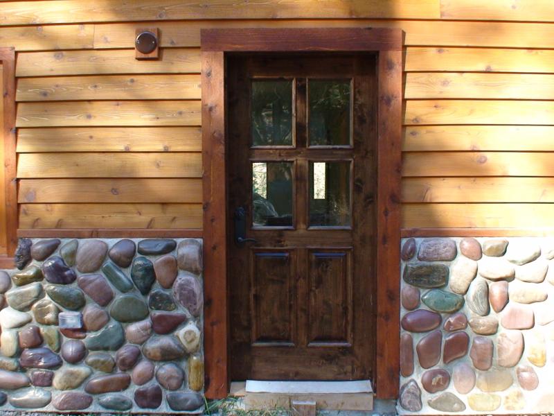 Knotty alder with raised panels and applied moulding